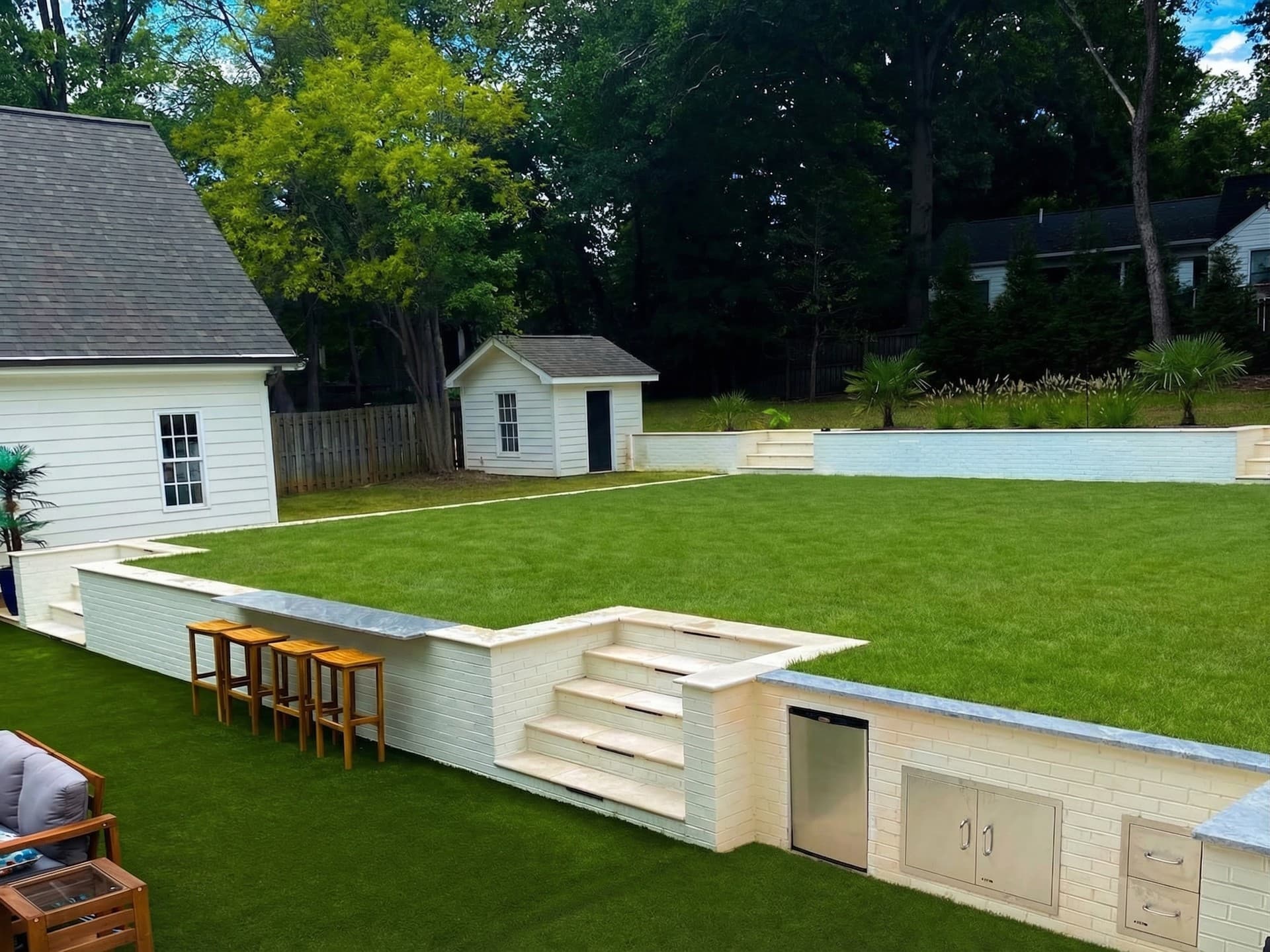 Empty backyard with green lawn before pool construction by Blue Waters